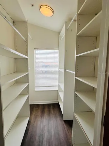 a view of walk in closet with empty racks