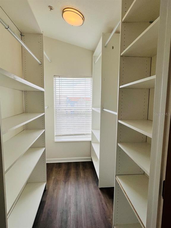 101 Palm Harbor Parkway, Unit A404 Palm Coast, FL 32137 - Photo 11 of 16 a view of walk in closet with empty racks