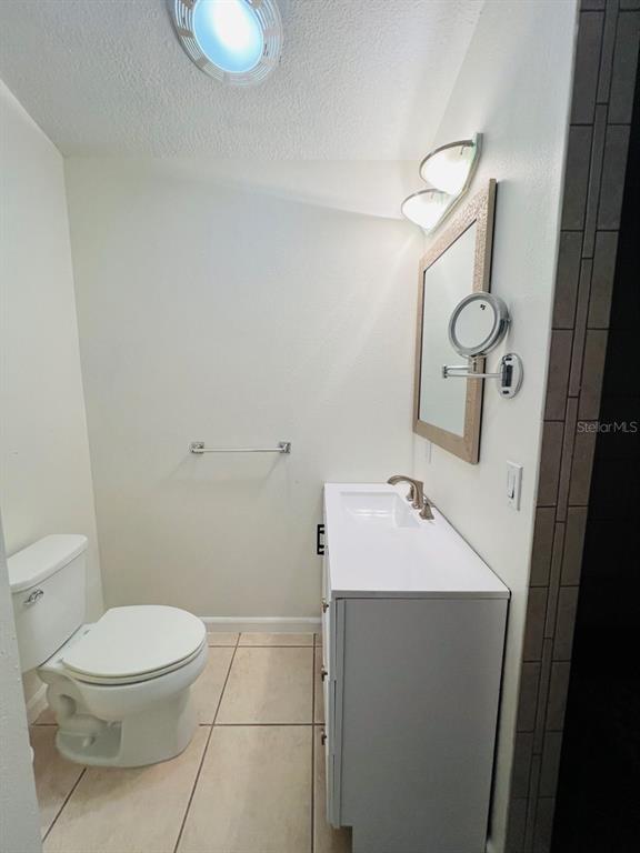 101 Palm Harbor Parkway, Unit A404 Palm Coast, FL 32137 - Photo 13 of 16 a bathroom with a sink toilet and mirror