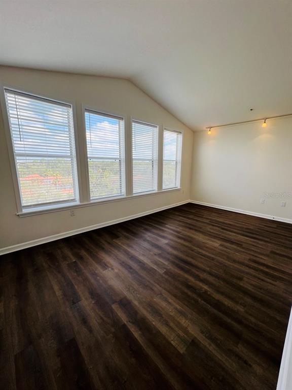101 Palm Harbor Parkway, Unit A404 Palm Coast, FL 32137 - Photo 14 of 16 a view of an empty room with wooden floor and a window