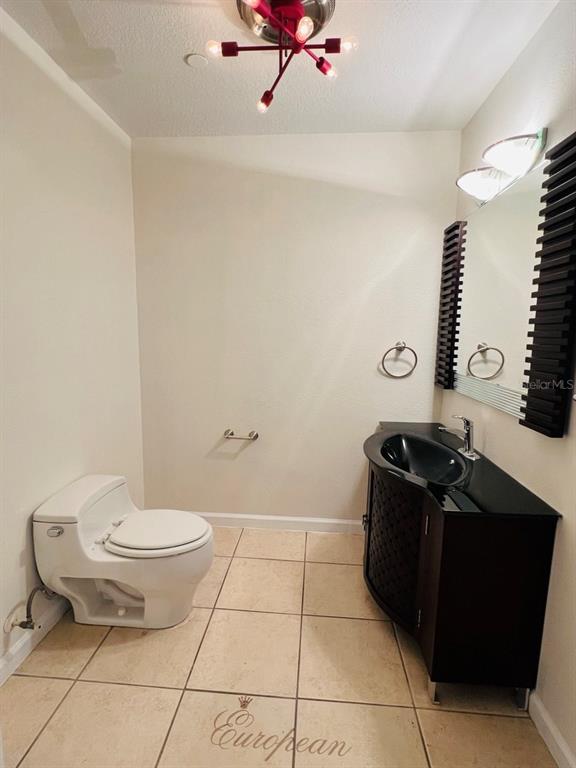 101 Palm Harbor Parkway, Unit A404 Palm Coast, FL 32137 - Photo 5 of 16 a bathroom with a sink toilet and a mirror
