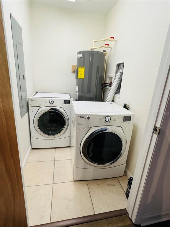 101 Palm Harbor Parkway, Unit A404 Palm Coast, FL 32137 - Photo 6 of 16 a utility room with dryer and washer
