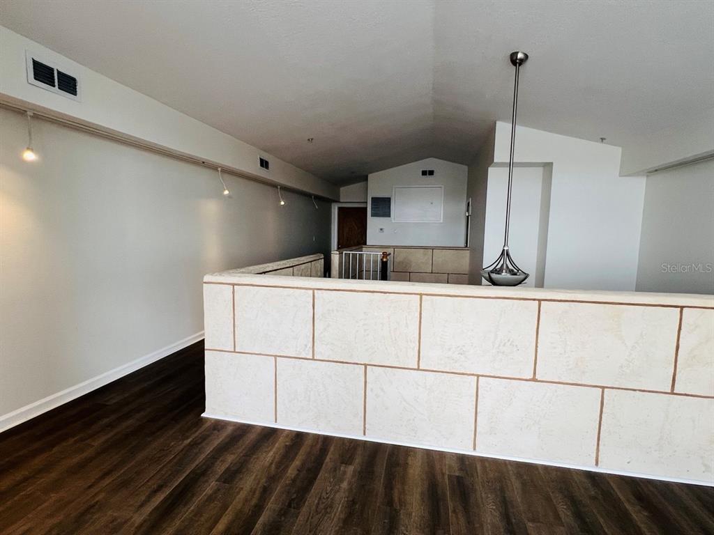 101 Palm Harbor Parkway, Unit A404 Palm Coast, FL 32137 - Photo 8 of 16 a kitchen with kitchen island a sink appliances and cabinets