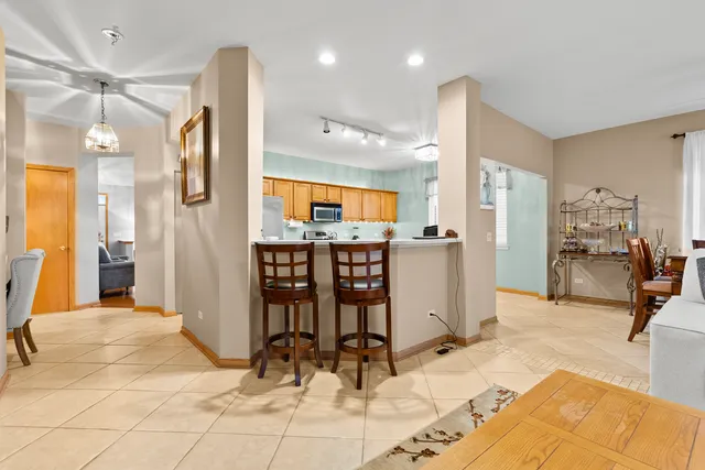 a view of a kitchen with dining area and windows
