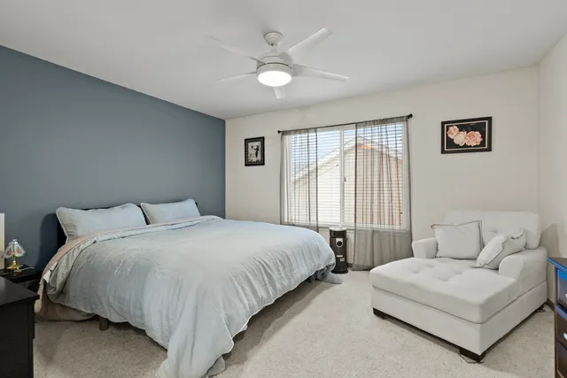 a bedroom with a large bed and a large window
