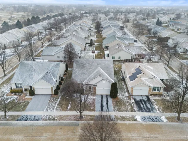 an aerial view of a house with a yard