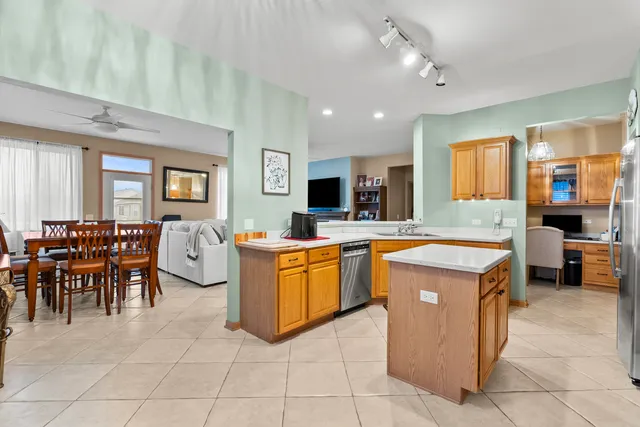 a kitchen with cabinets and chairs
