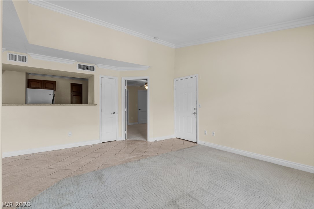 8101 West Flamingo Road, Unit 2001 Las Vegas, NV 89147 - Photo 6 of 28 A versatile living space offering seamless transitions from carpeted comfort to tiled functionality.