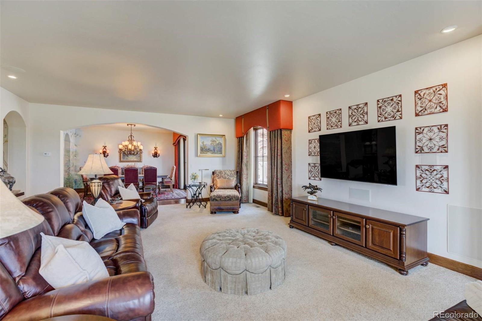 14250 Aiken Ride View Colorado Springs, CO 80926 - Photo 13 of 50 a living room with furniture and a flat screen tv