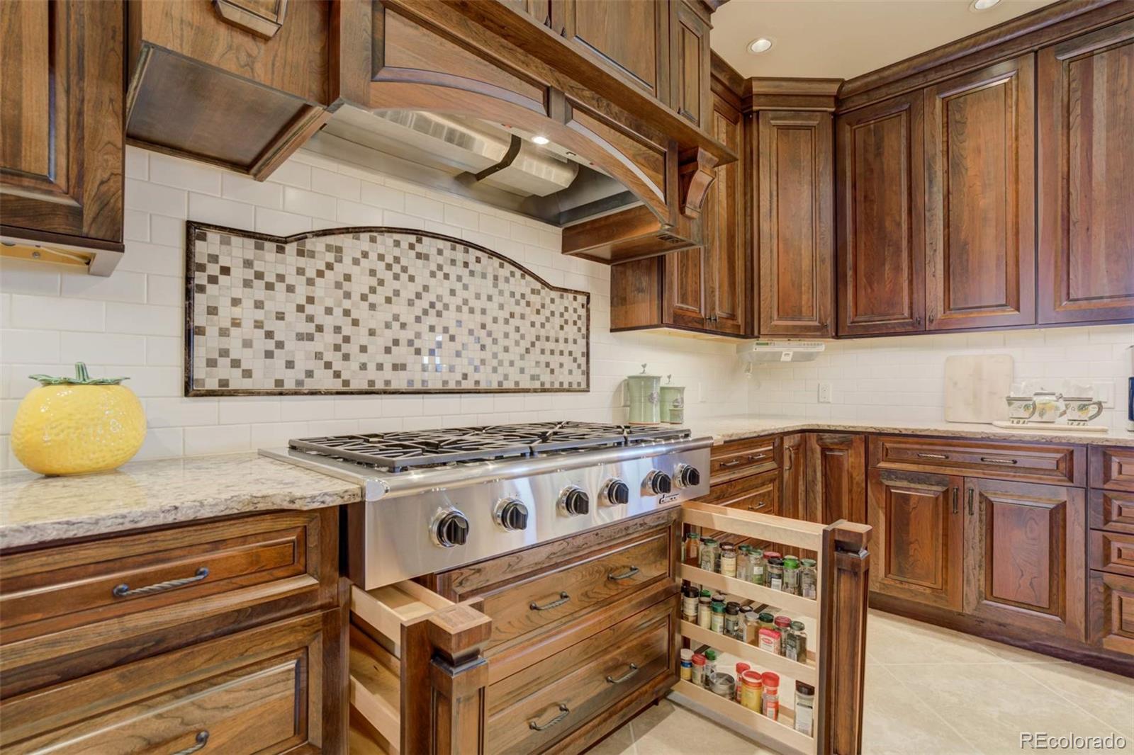 14250 Aiken Ride View Colorado Springs, CO 80926 - Photo 19 of 50 a white stove top oven sitting inside of a kitchen