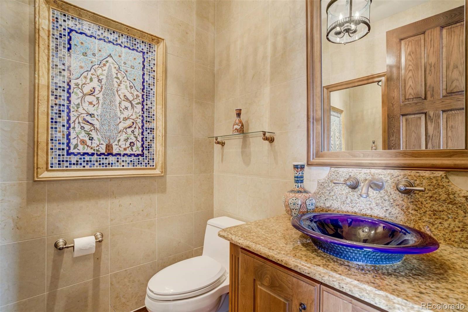 14250 Aiken Ride View Colorado Springs, CO 80926 - Photo 29 of 50 a bathroom with a granite countertop toilet sink and mirror