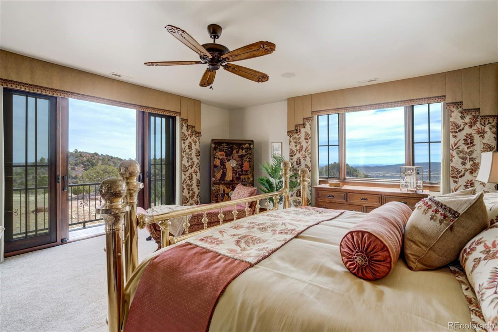 14250 Aiken Ride View Colorado Springs, CO 80926 - Photo 33 of 50 a bedroom with a bed and a large window
