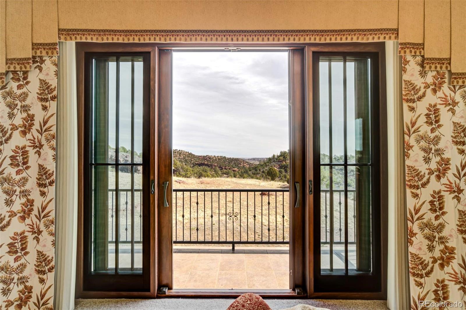 14250 Aiken Ride View Colorado Springs, CO 80926 - Photo 35 of 50 a view of a glass door with a door
