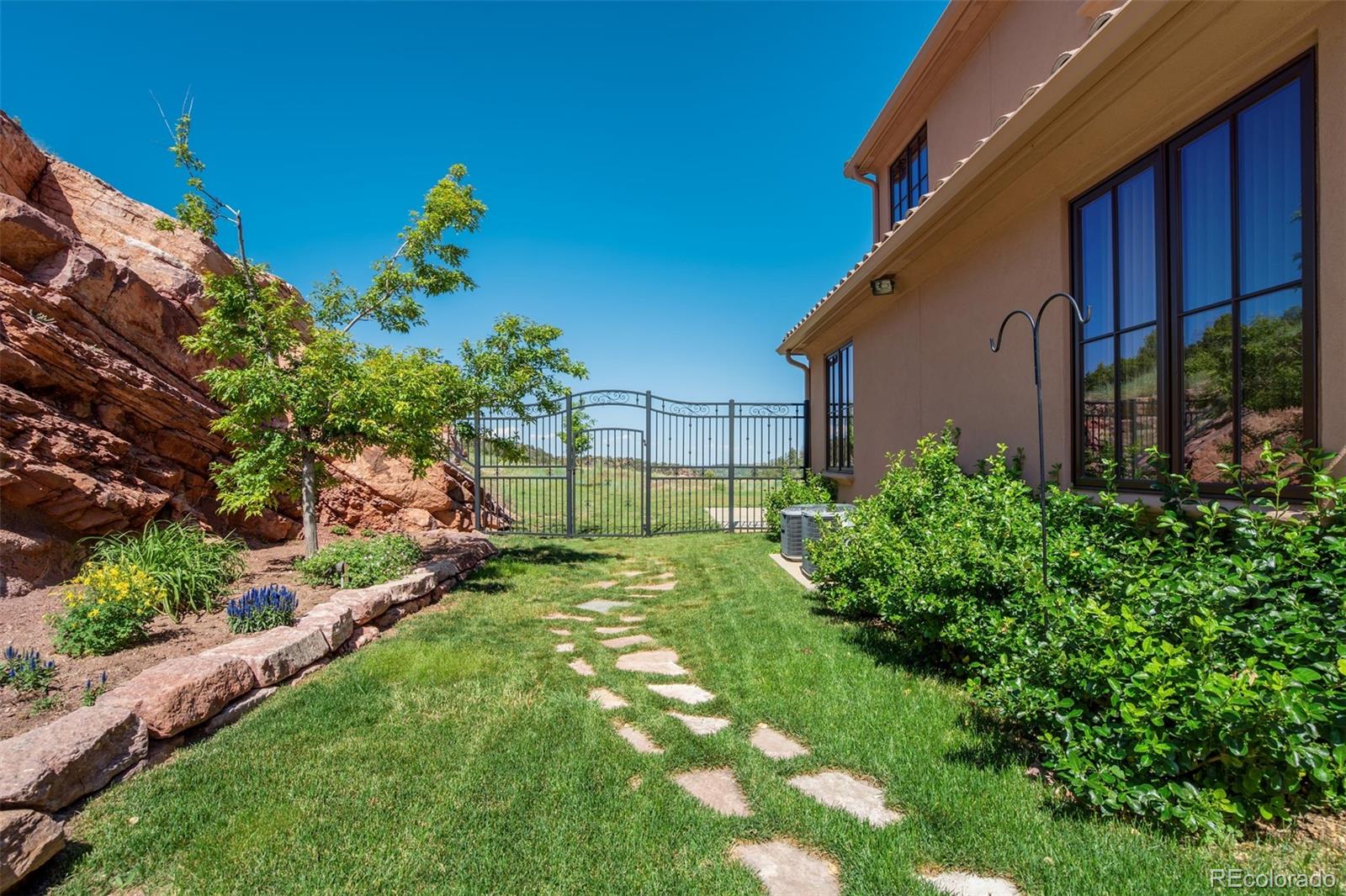 14250 Aiken Ride View Colorado Springs, CO 80926 - Photo 44 of 50 a view of a backyard with plants