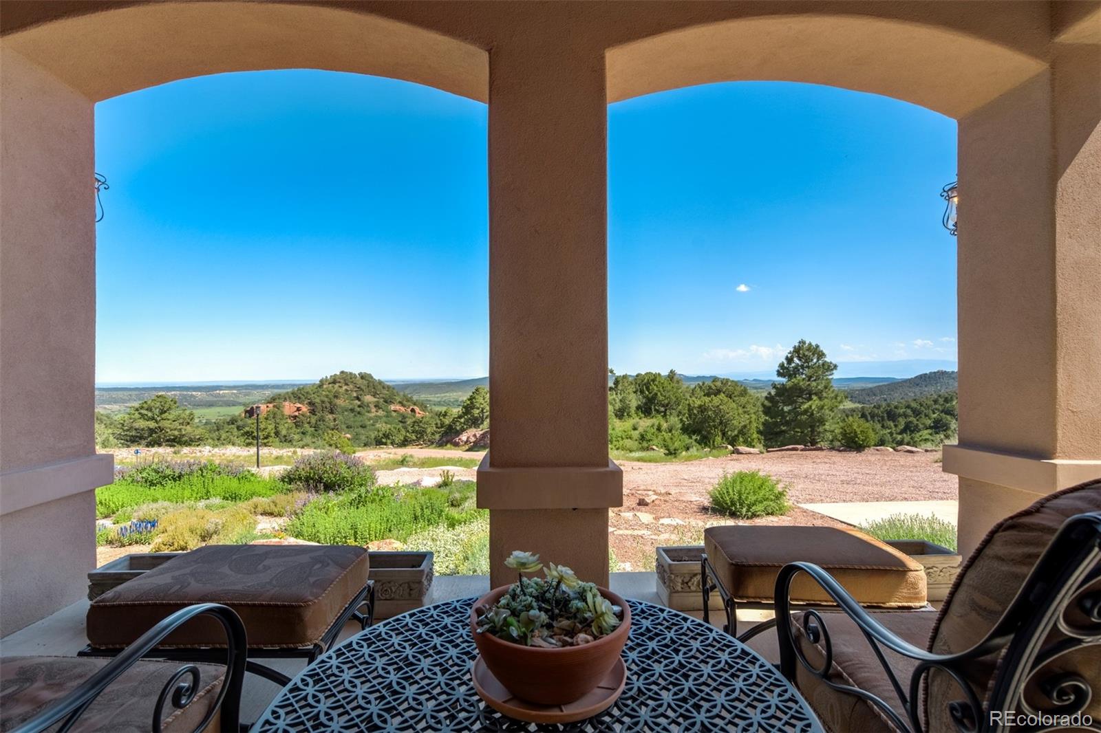 14250 Aiken Ride View Colorado Springs, CO 80926 - Photo 45 of 50 a view of balcony with two chairs and a potted plant