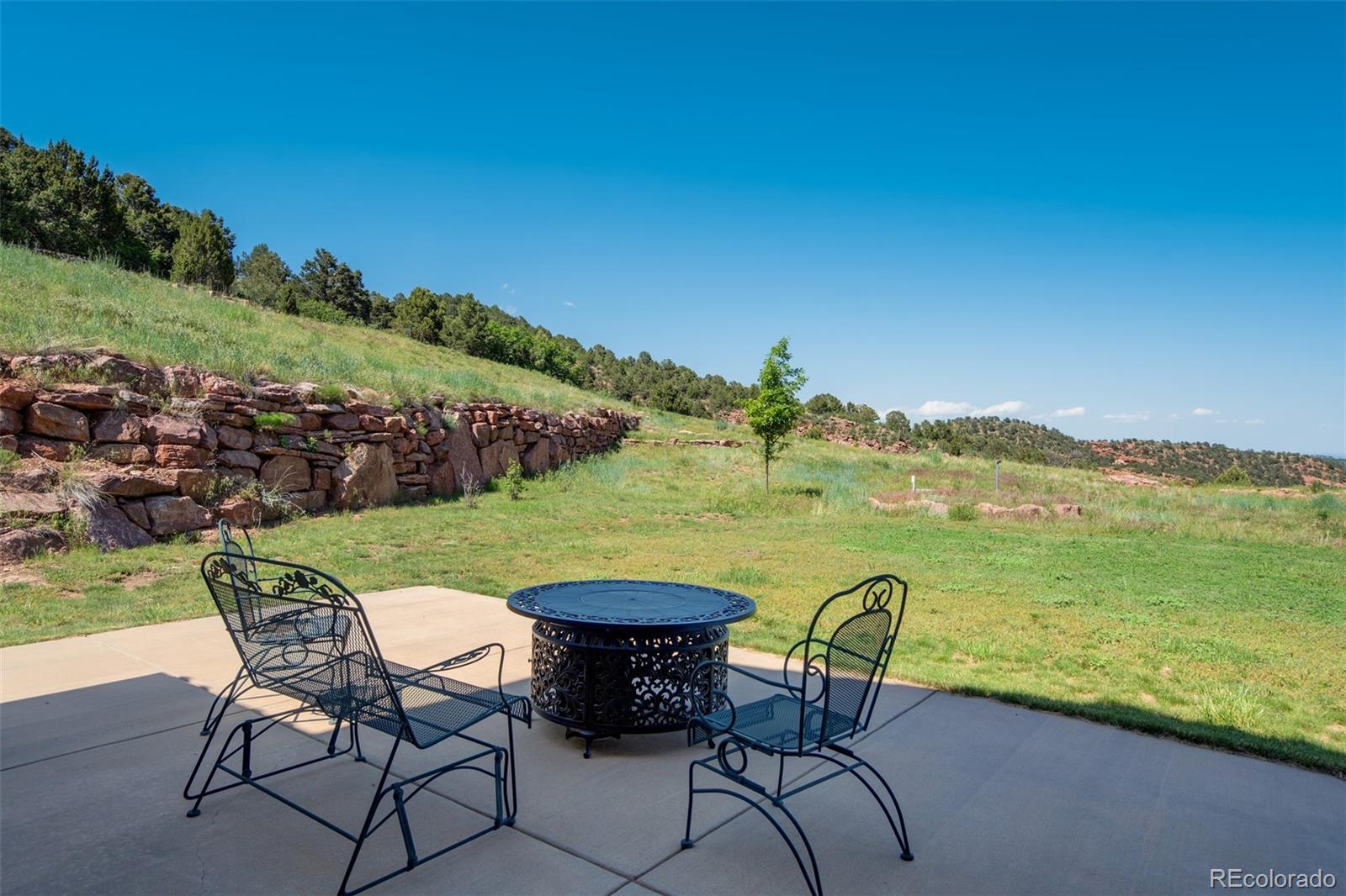 14250 Aiken Ride View Colorado Springs, CO 80926 - Photo 48 of 50 a view of a lake with table and chairs