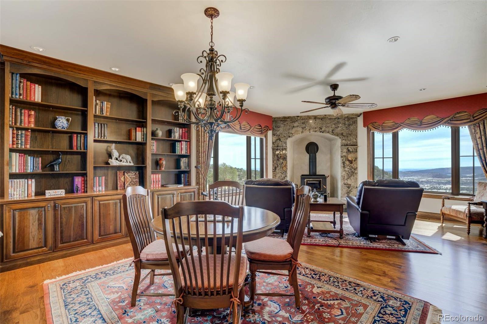 14250 Aiken Ride View Colorado Springs, CO 80926 - Photo 5 of 50 a view of a dining room with furniture window and wooden floor