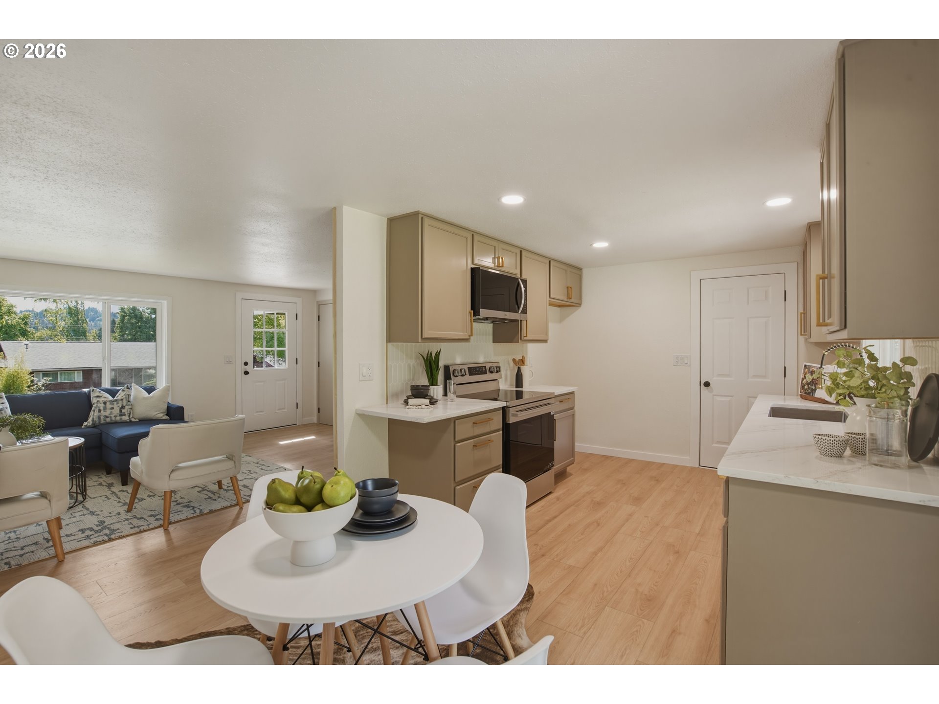 3455 Potter Street Eugene, OR 97405 - Photo 17 of 36 a kitchen with sink refrigerator dining table and chairs