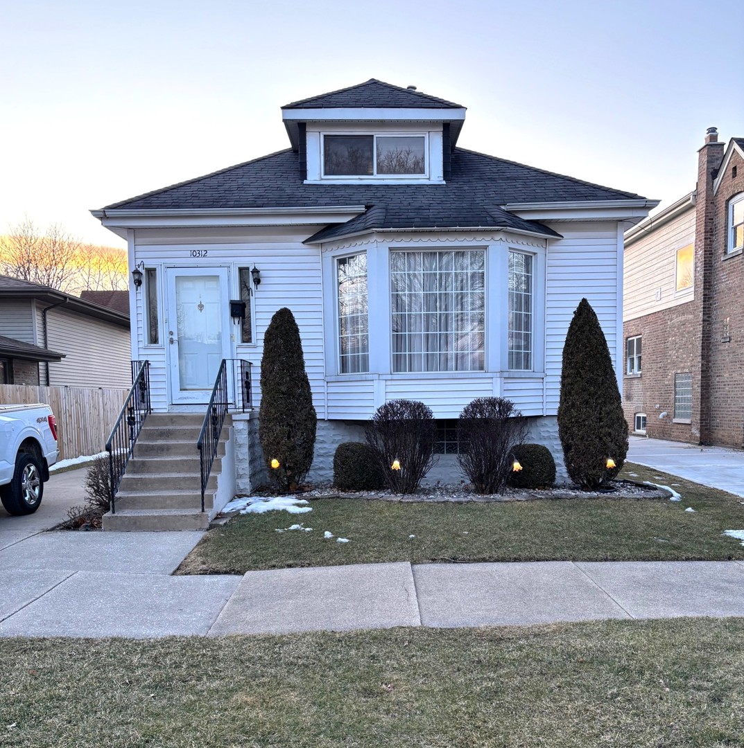 10312 South Spaulding Avenue Chicago, IL 60655 - Photo 1 of 5 a front view of a house with garage
