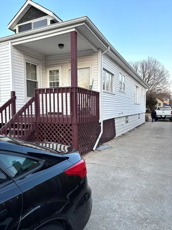 a view of a house with a wooden fence
