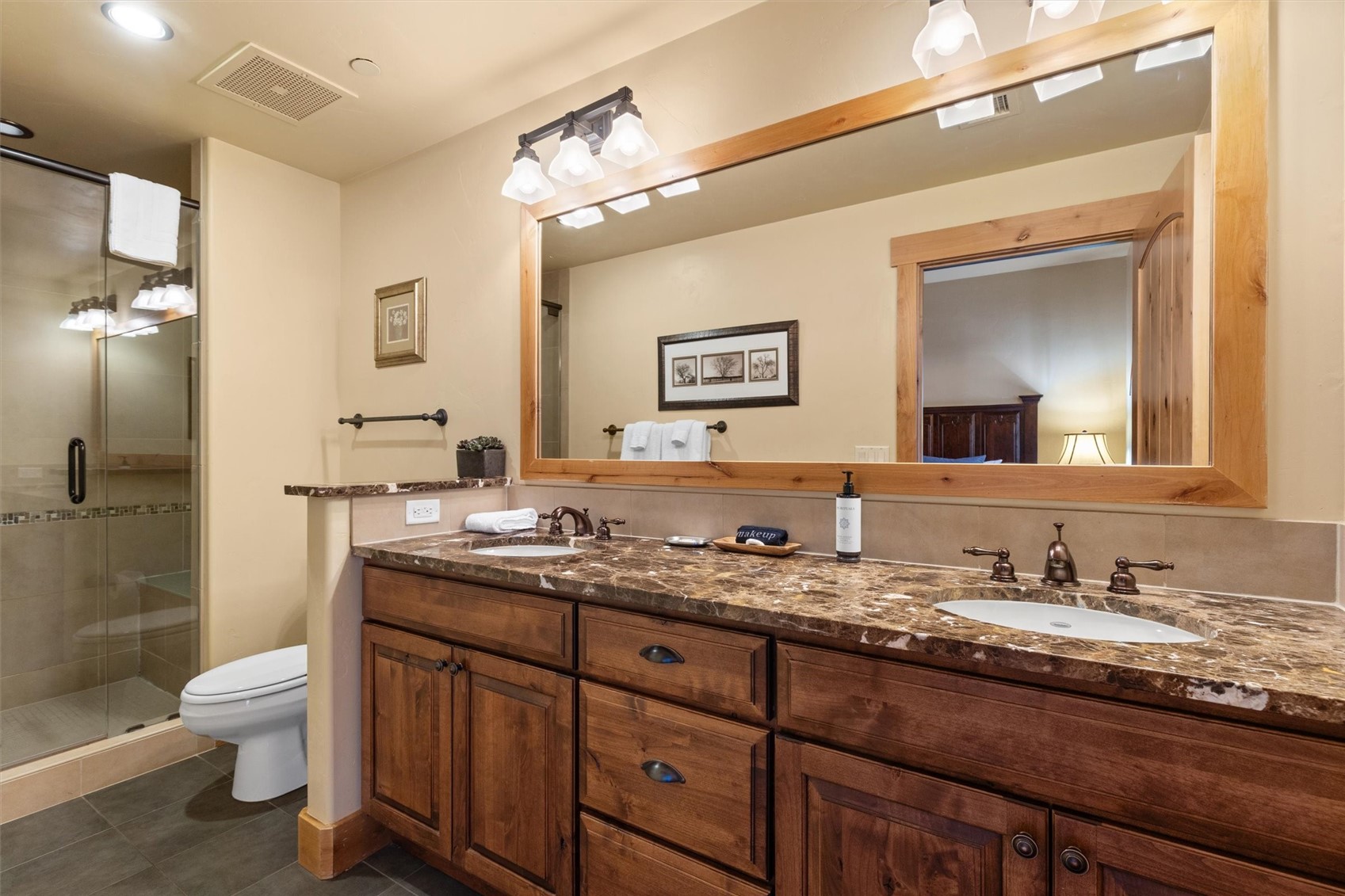 1750 Medicine Springs Road, Unit 6105 Steamboat Springs, CO 80487 - Photo 13 of 43 a bathroom with a granite countertop toilet sink and mirror