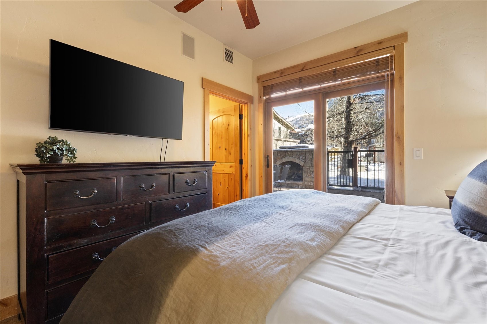 1750 Medicine Springs Road, Unit 6105 Steamboat Springs, CO 80487 - Photo 19 of 43 a bedroom with a bed and a flat tv screen on dresser