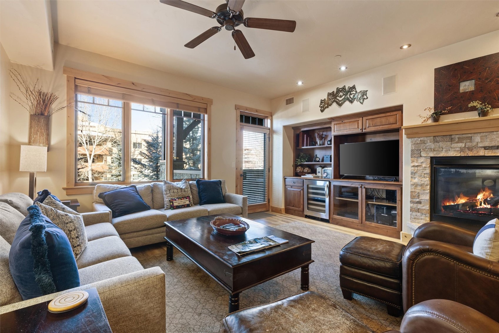 1750 Medicine Springs Road, Unit 6105 Steamboat Springs, CO 80487 - Photo 2 of 43 a living room with furniture a flat screen tv and a fireplace