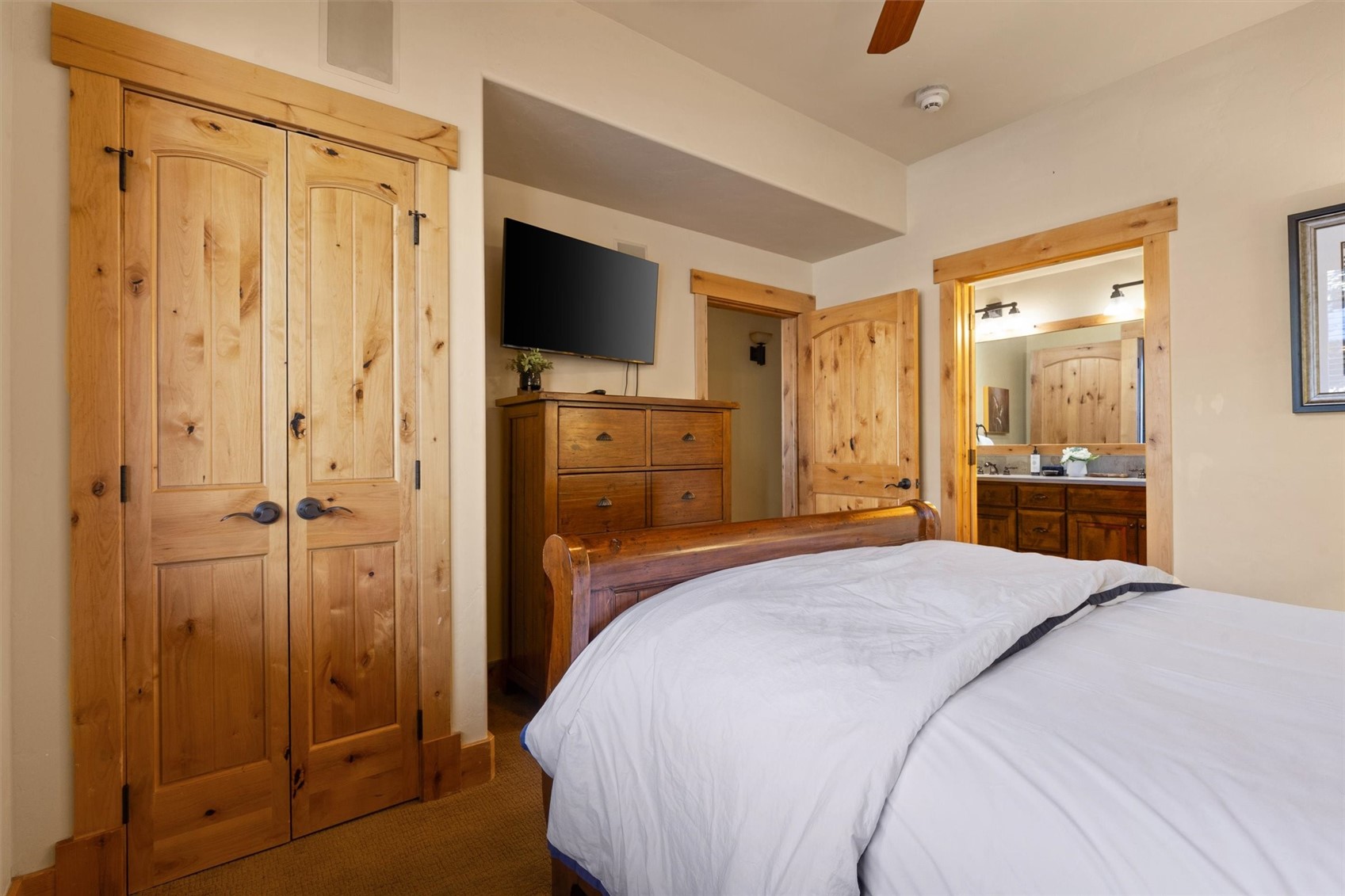 1750 Medicine Springs Road, Unit 6105 Steamboat Springs, CO 80487 - Photo 22 of 43 a spacious bedroom with a bed and a flat tv screen
