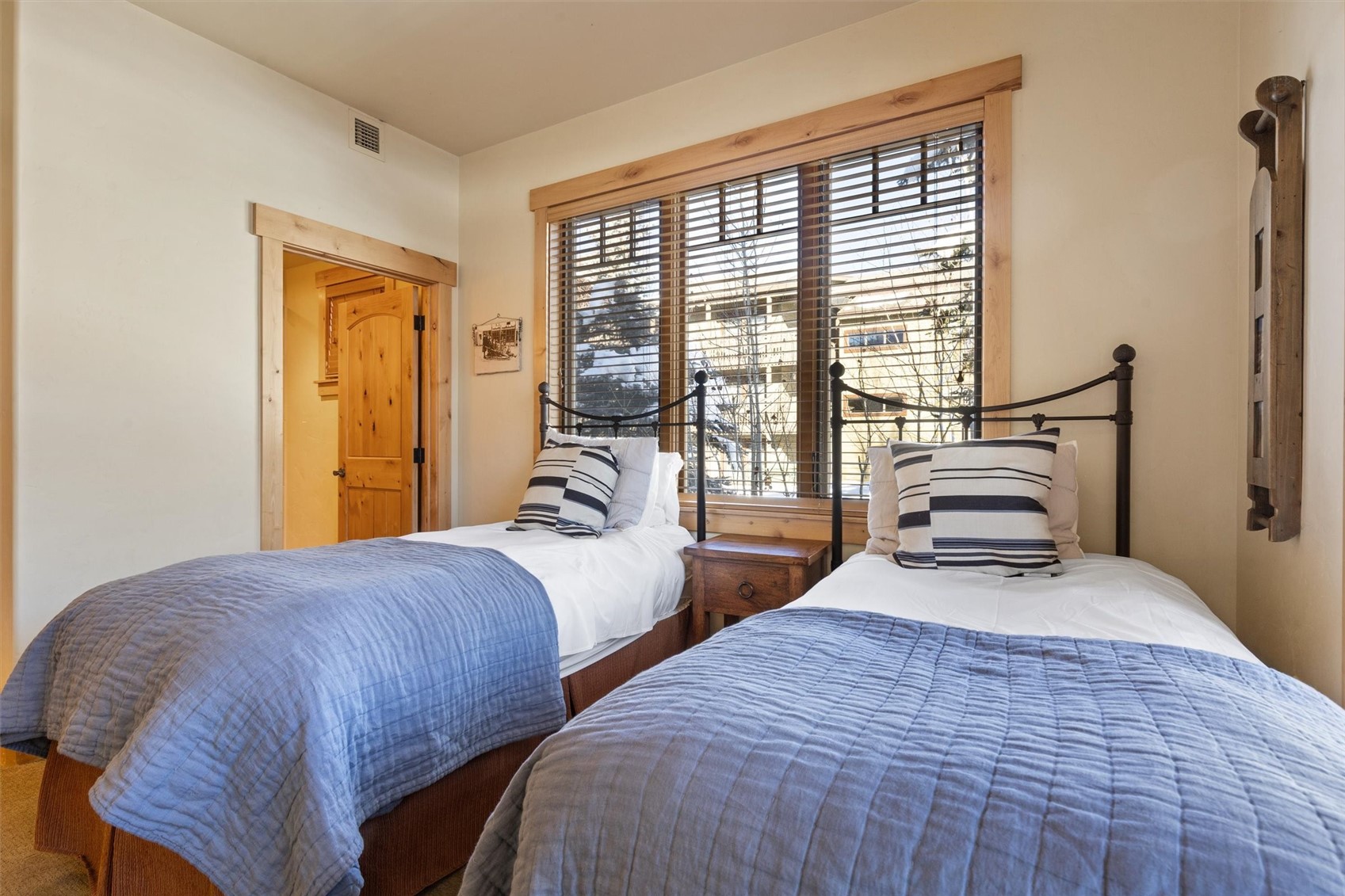 1750 Medicine Springs Road, Unit 6105 Steamboat Springs, CO 80487 - Photo 26 of 43 a bedroom with two beds and a large window