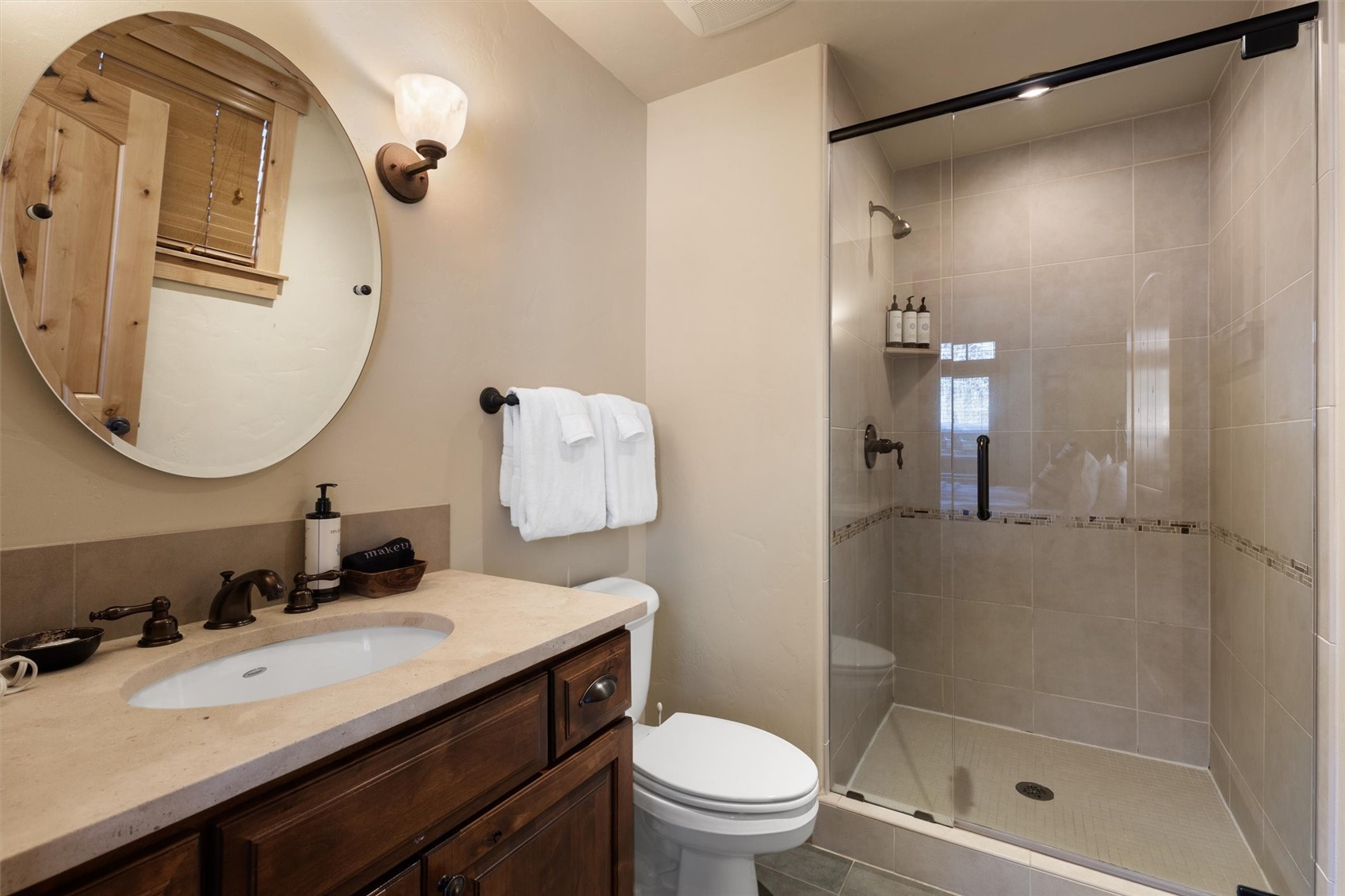 1750 Medicine Springs Road, Unit 6105 Steamboat Springs, CO 80487 - Photo 27 of 43 a bathroom with a granite countertop sink toilet and shower