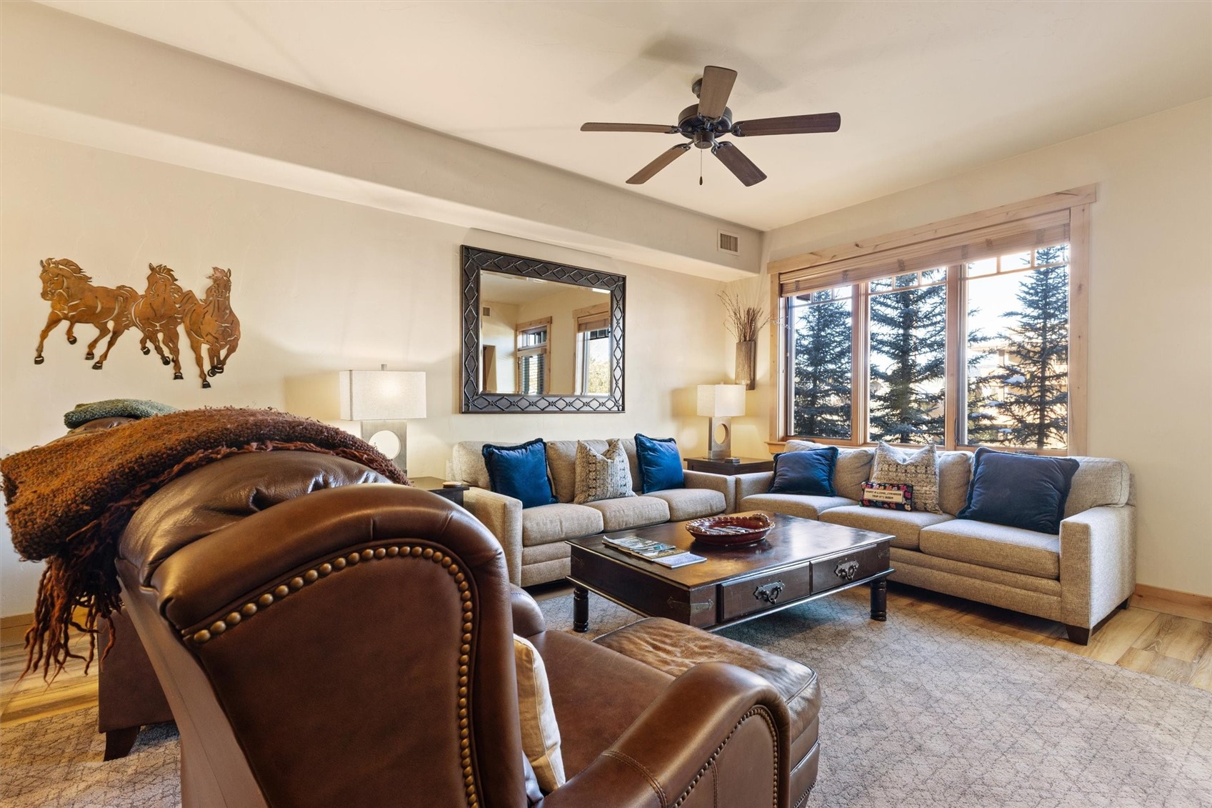 1750 Medicine Springs Road, Unit 6105 Steamboat Springs, CO 80487 - Photo 3 of 43 a living room with furniture ceiling fan and a rug