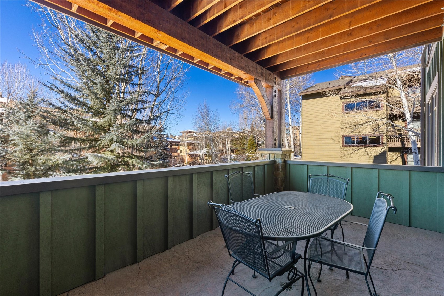 1750 Medicine Springs Road, Unit 6105 Steamboat Springs, CO 80487 - Photo 34 of 43 a view of a balcony with table and chairs
