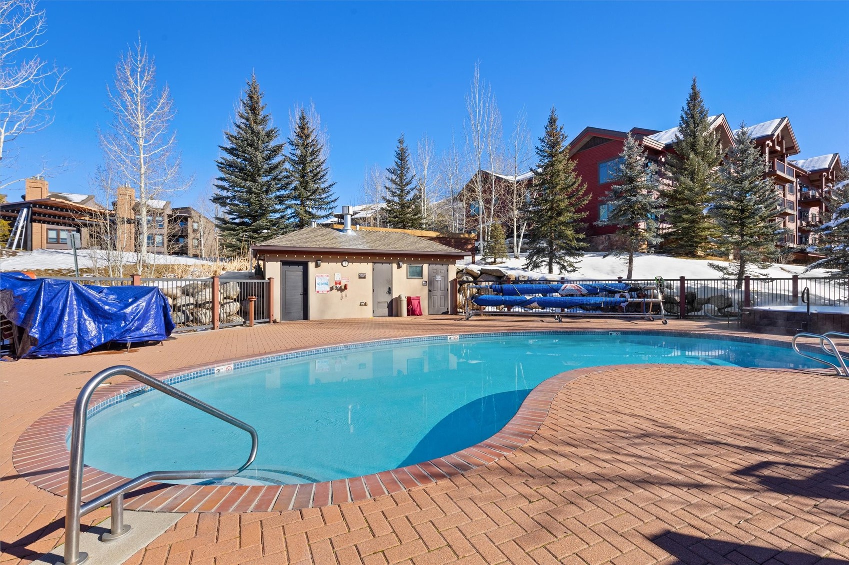 1750 Medicine Springs Road, Unit 6105 Steamboat Springs, CO 80487 - Photo 37 of 43 a view of a swimming pool with a deck and a chairs
