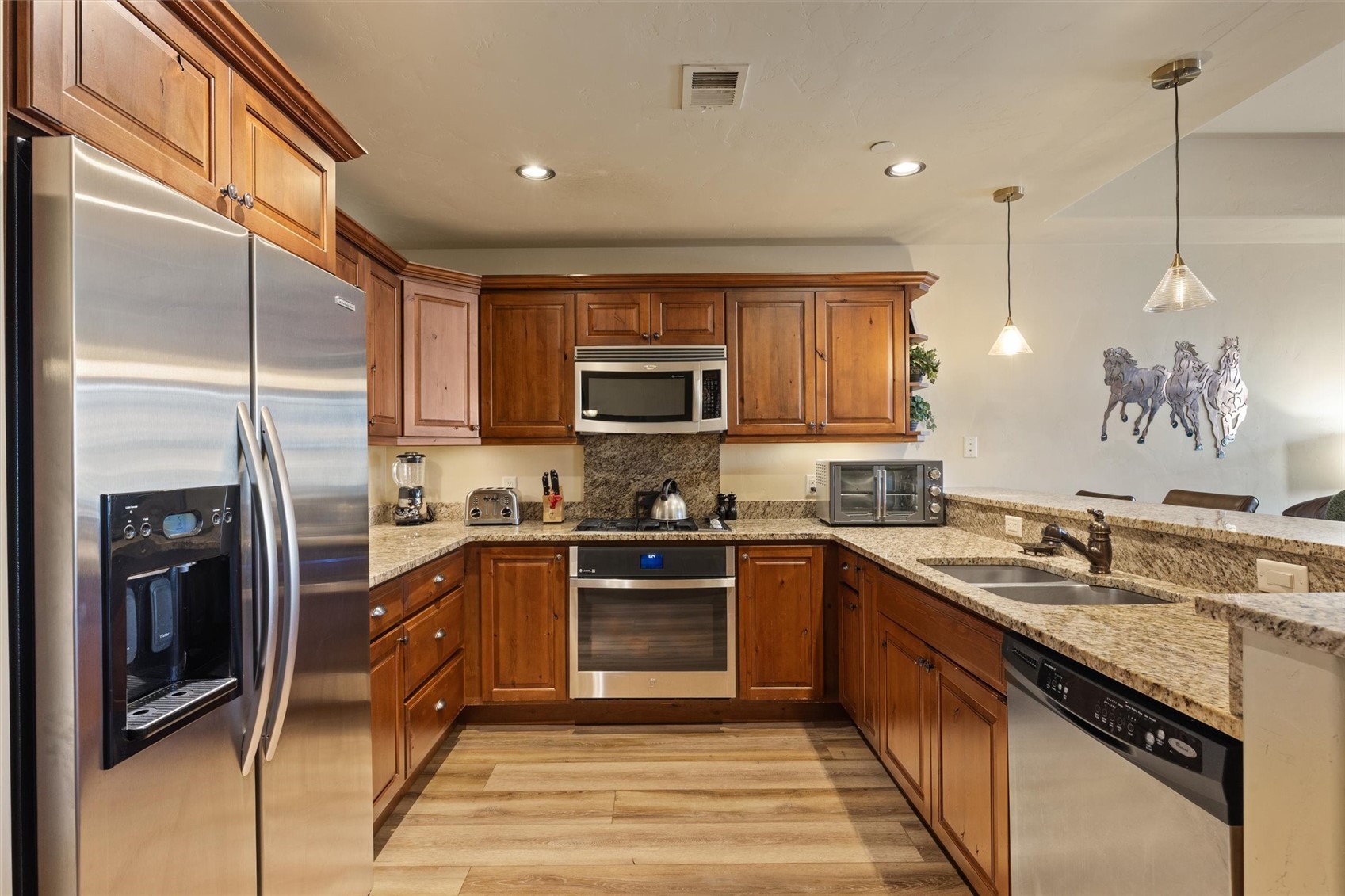 1750 Medicine Springs Road, Unit 6105 Steamboat Springs, CO 80487 - Photo 7 of 43 a kitchen with granite countertop a sink a counter top space stainless steel appliances and cabinets