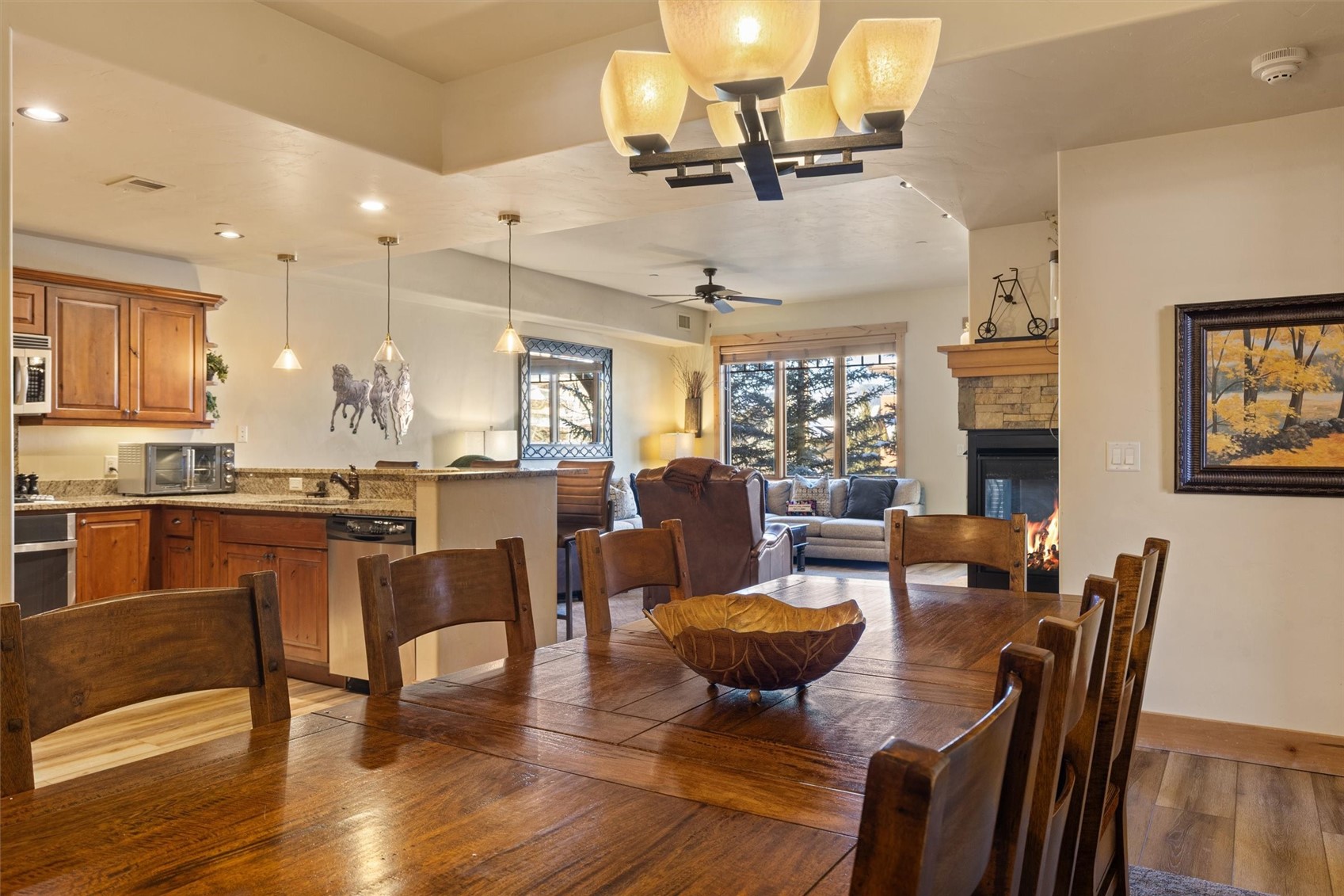 1750 Medicine Springs Road, Unit 6105 Steamboat Springs, CO 80487 - Photo 9 of 43 a view of a dining room with furniture a chandelier and wooden floor
