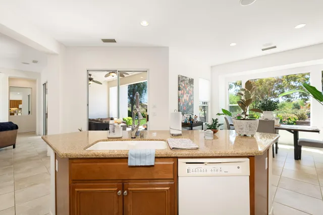 a view of a dining room with furniture and a potted plant