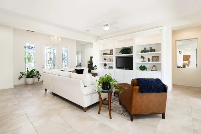 a living room with furniture potted plant and a window