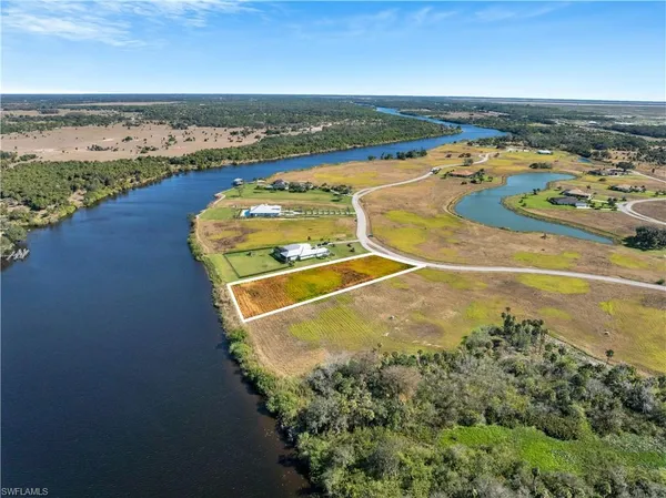 an aerial view of a residential houses with outdoor space and ocean view