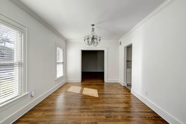 a view of a hallway with wooden floor and a fireplace