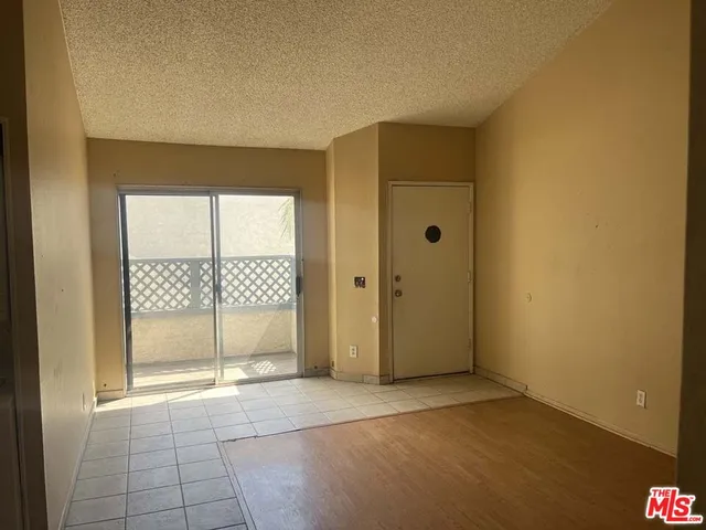 a view of a patio with table and chairs and potted plants