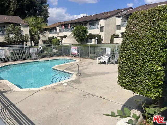 a white house that has a tree in front of it