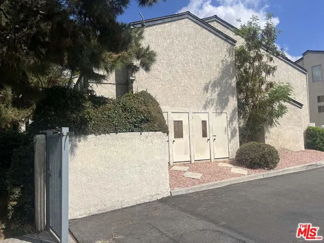a view of house with backyard and patio