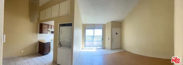 a view of a hallway with wooden floor and closet