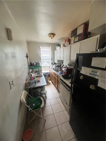 a kitchen with furniture a stove and a refrigerator