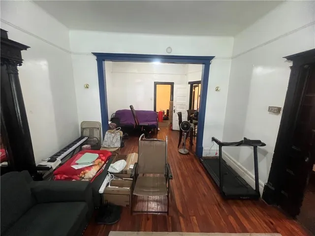 a living room with furniture a couch and wooden floor