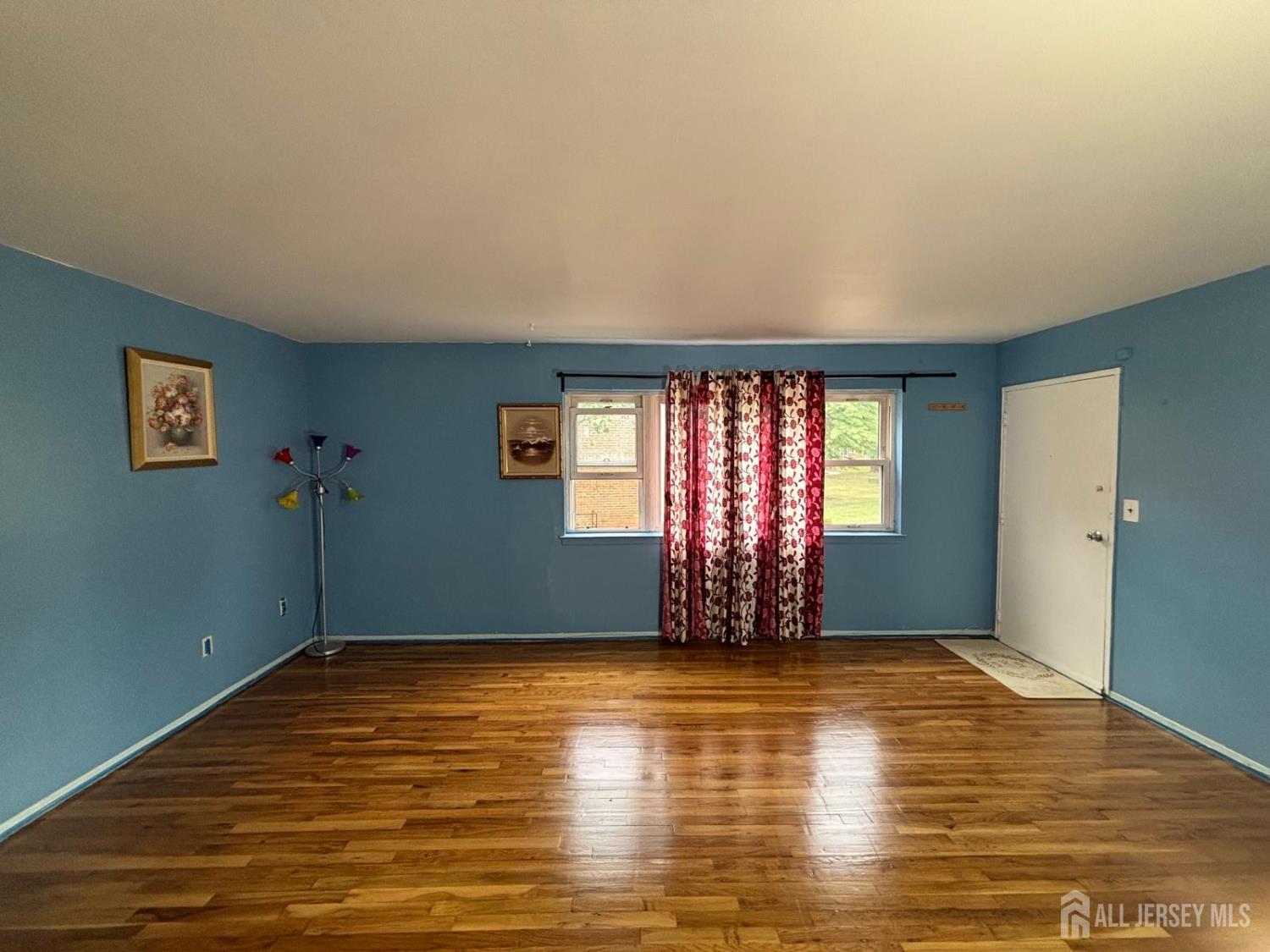 30 Judson Street, Unit 8A Edison, NJ 08837 - Photo 5 of 7 a view of an empty room with window wooden floor