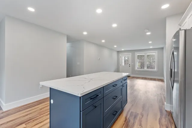 a view of kitchen with granite countertop cabinets and wooden floor