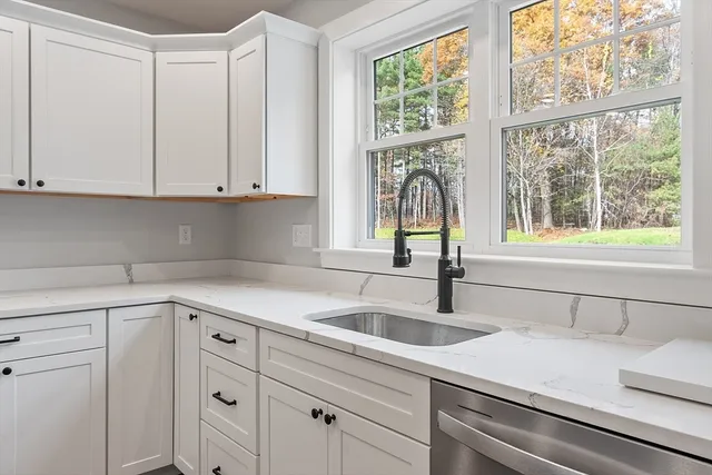 a kitchen with appliances cabinets and a window