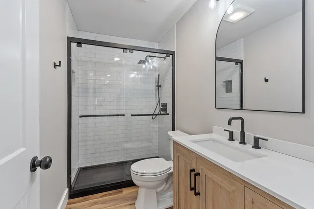 a bathroom with a sink toilet and shower