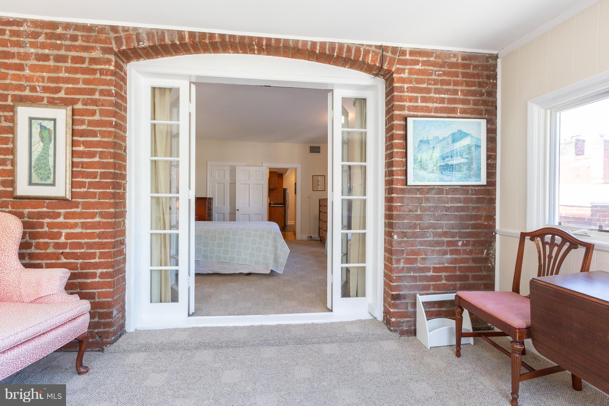 2321 Ashmead Place Northwest Washington, DC 20009 - Photo 20 of 30 Unit 2 Sun Room with Exposed Brick